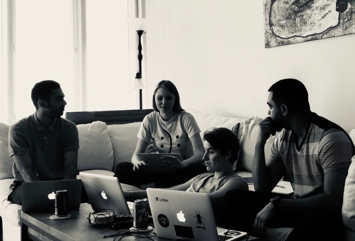 Aphid team collaborating in a living room with laptops